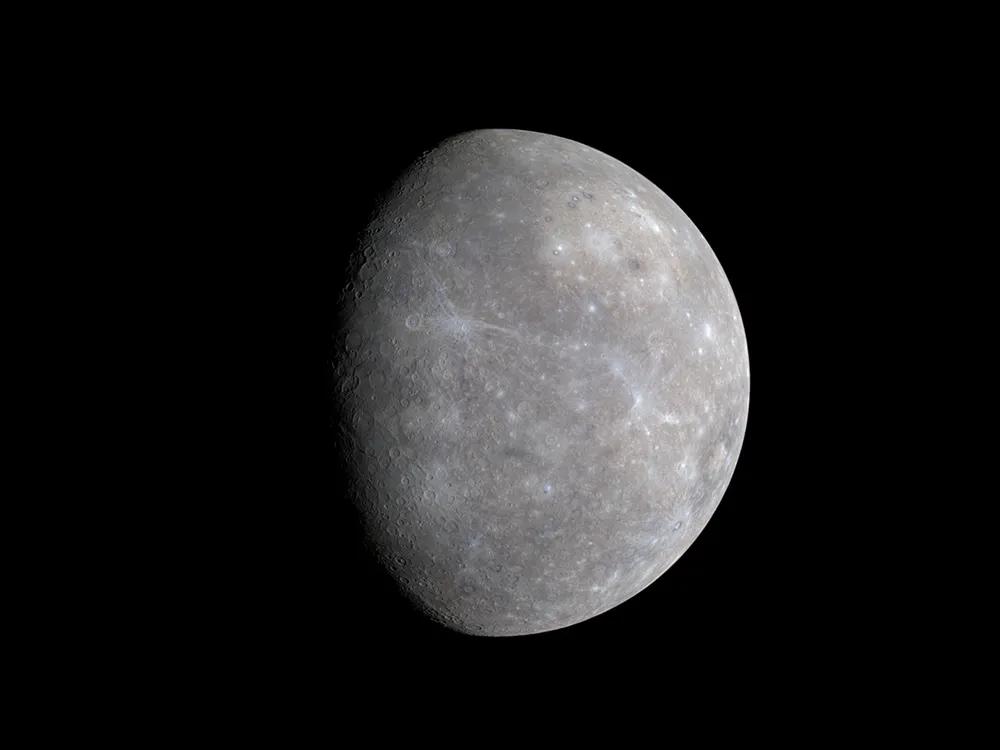 An image of planet Mercury showing its cratered surface and sublte color