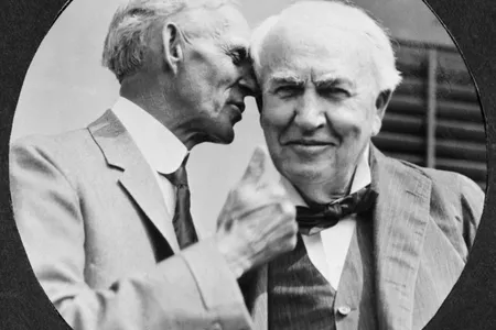 Henry Ford whispers in Thomas Edison's ear