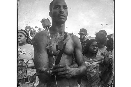 In Ferguson, Missouri, a protester holds a rose during an August demonstration on W. Florissant Avenue, which intersects with Canfield Drive—the street where Michael Brown was killed.