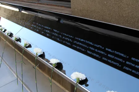 Flowers on the memorial for the 146 victims of the Triangle Shirtwaist Factory fire during its dedication on October 11