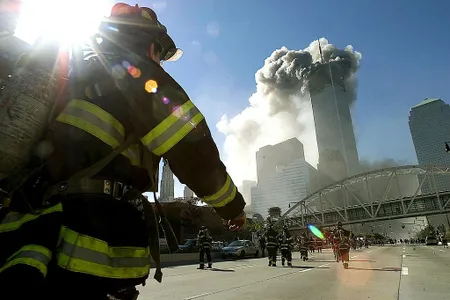 Firefighters walk towards one of the towers at the World Trade Center before it collapsed on September 11, 2001.