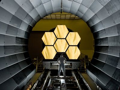 A scientist looks at mirror segments for the NASA's James Webb Space Telescope. The mirrors underwent cryogenic testing—made possible by scarce helium gas—to see how they would respond to extreme temperatures. Now, scientists have found a huge cache of helium gas that could make the element more accessible to scientists. 