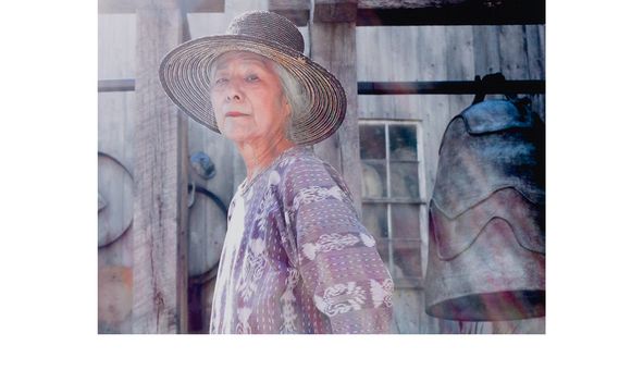 Photograph of Toshiko Takaezu posing with work (detail), September 2004. Toshiko Takaezu papers, 1937-2010. Archives of American Art, Smithsonian Institution.