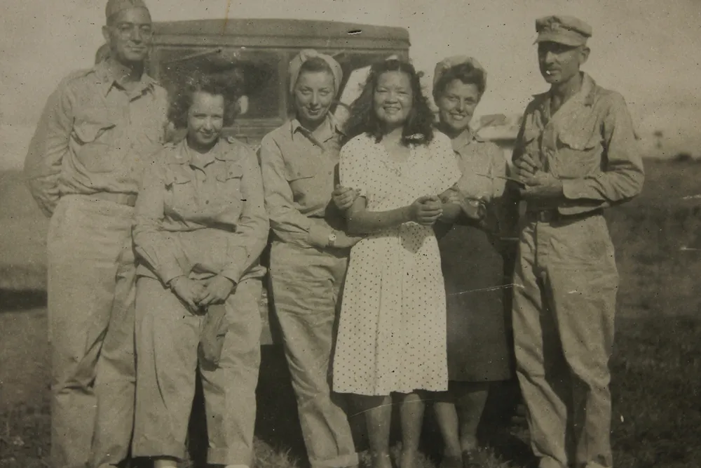 Josefina Guerrero and Americans stand in a field