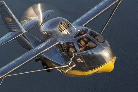 A Republic Seabee, the ideal sportplane, climbs over a Wisconsin lake.