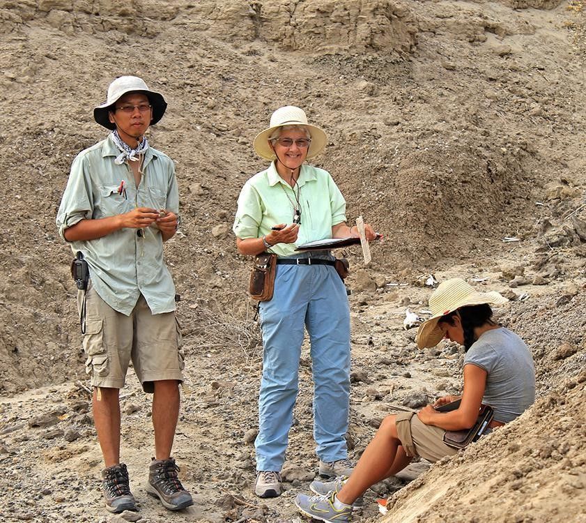 A group of people standing in a desert.