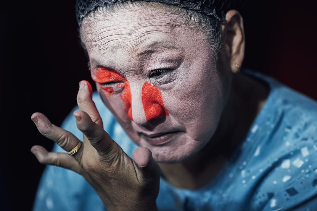 9 - An opera performer applies heavy makeup during celebrations of Thailand’s annual Vegetarian Festival.