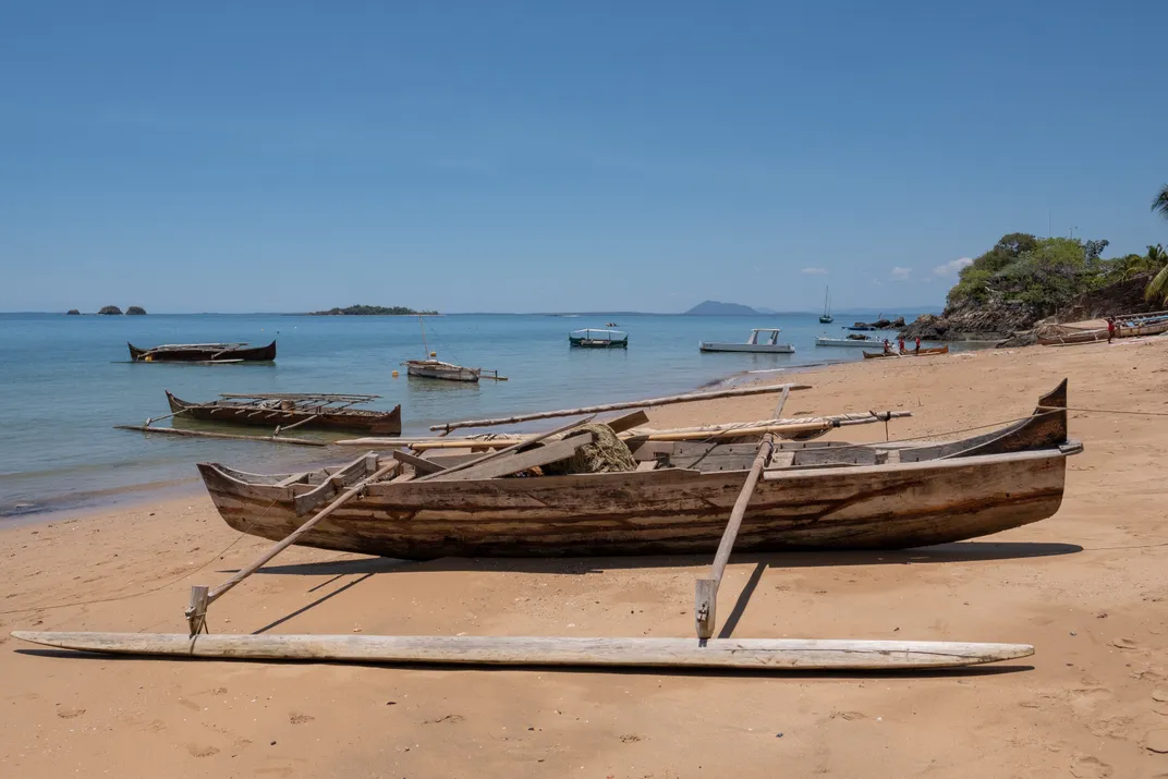 A traditional dugout with outriggers on a beach in Nosy Be, Madagascar