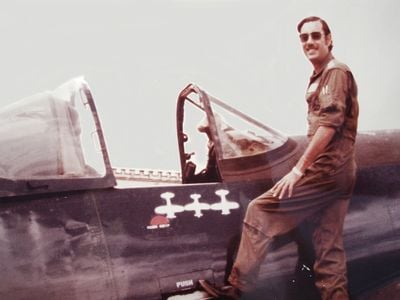 Fernando Soto in 1970 atop his Honduran Corsair, with symbols marking his victories. The aircraft is now in the Honduras air museum, which keeps it in running (but not flying) condition.