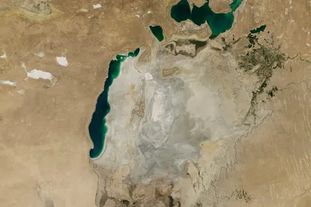 The Aral Sea as of August 19, 2014. The black outline shows the lake's extent in 1960.