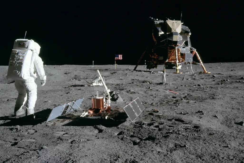 An astronaut on the surface of the moon with some equipment