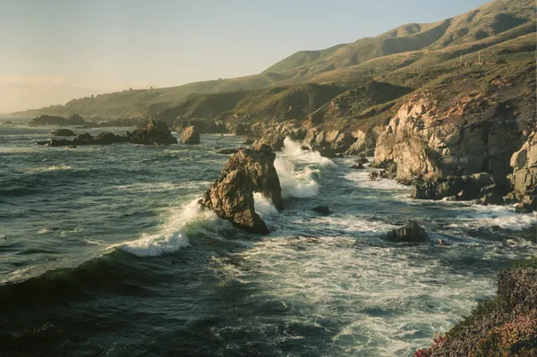 Waves crashing against a rock formation on the coast of Big Sur thumbnail