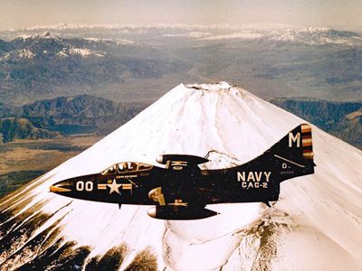 A U.S. Navy F9F Panther assigned to Carrier Air Group 2 cruises past Mount Fuji on a port call in Japan during the Korean War.