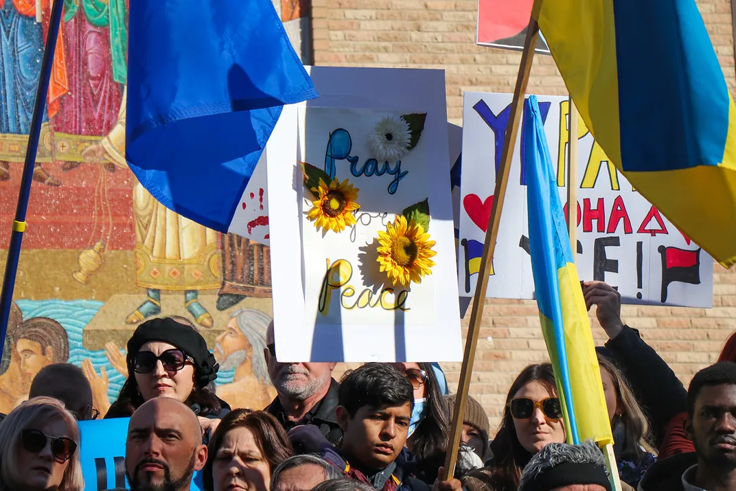 Protesters in Chicago holding up a sunflower