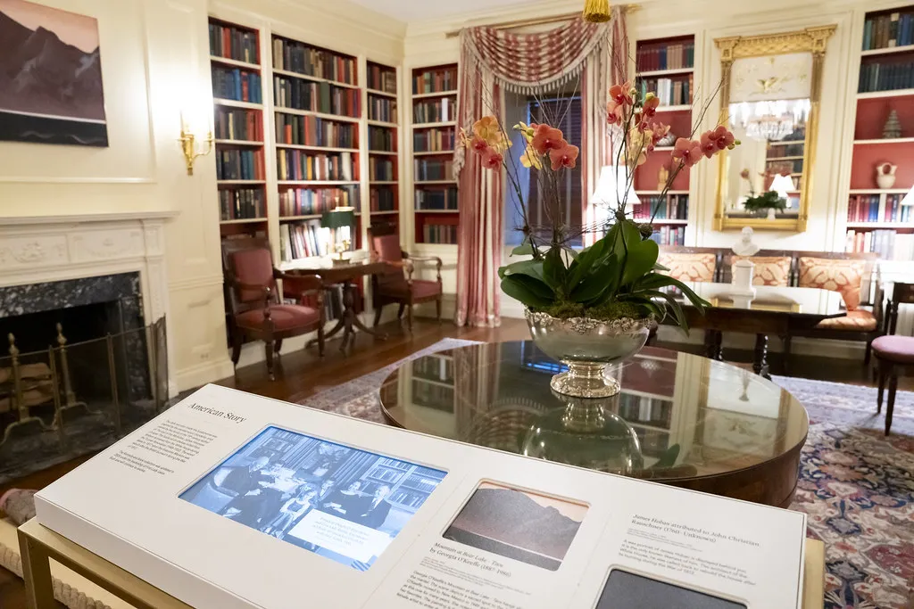 Interpretive stand with a video screen and text in front of a room in the White House