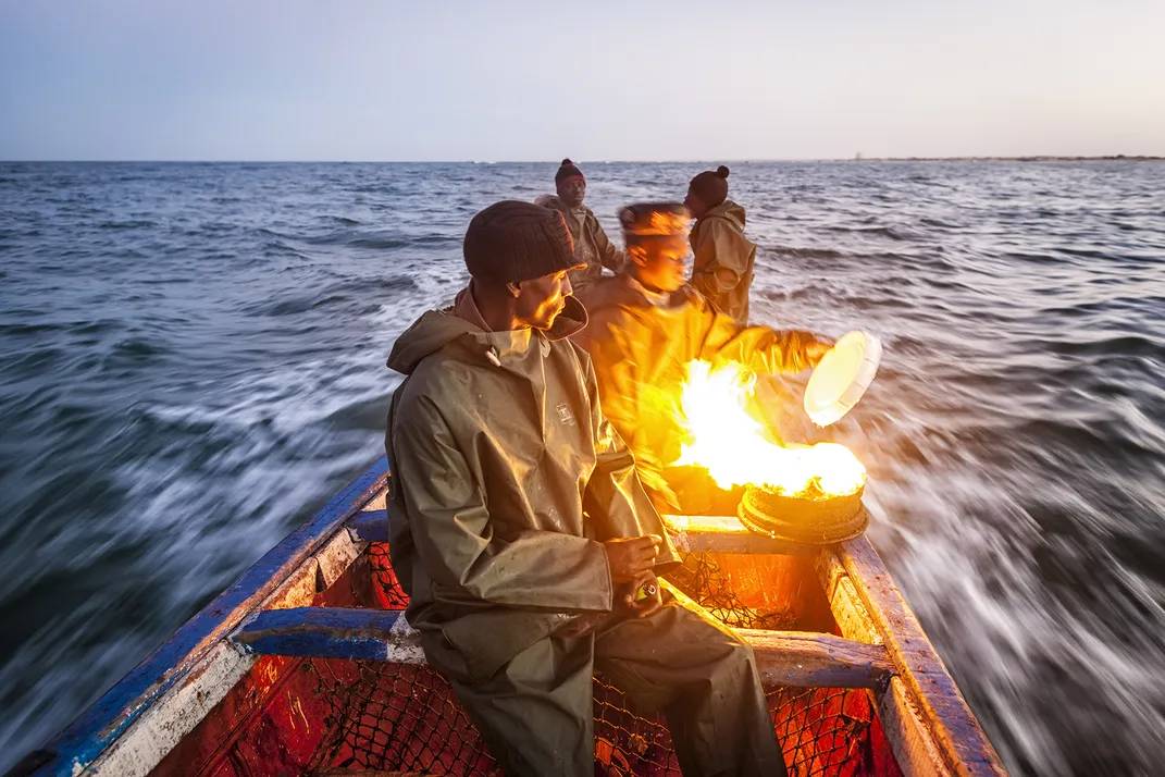 African fisherman on a small boat