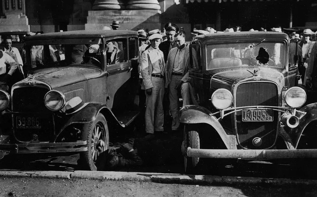 Kansas City residents watch the aftermath of the June 1933 Union Station shootout between law enforcement officials and outlaws.