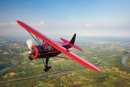 A beautifully restored Howard DGA built in 1943 cruises over Middletown Valley in western Maryland.