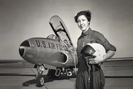 An undated photograph shows Wally Funk standing with a U.S. Air Force jet. 