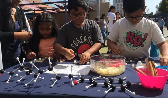 Children participate in a hands-on science activity with the Smithsonian Latino Center for a Dia del Niño festival hosted by LA Plaza de Cultura y Arte in Los Angeles, California. (Smithsonian Latino Center)