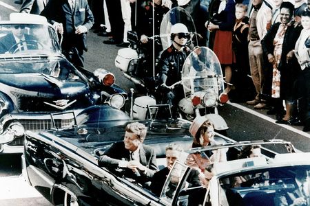 President John F. Kennedy in the presidential limousine before his assassination, on November 22, 1963, with his wife Jacqueline next to him.