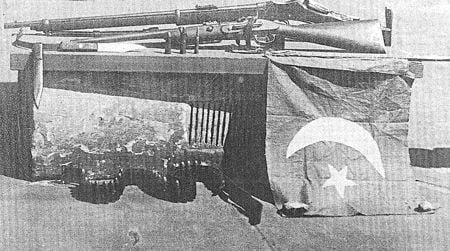 The Turkish flag flown, and rifles used, by Gool Mohammed and Mullah Abdullah during the Battle of Broken Hill, January 1, 1915.