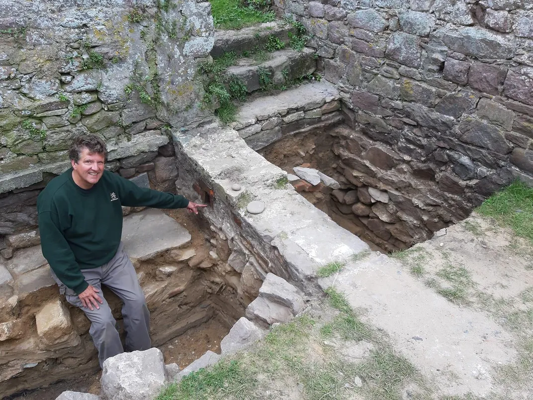 A researcher points to drainage structures at the Nunnery