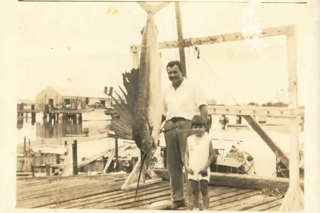 Ernest Hemingway and his middle son, Patrick, pose with a record 119.5-pound Atlantic sailfish caught off Key West, Florida, in May 1934.