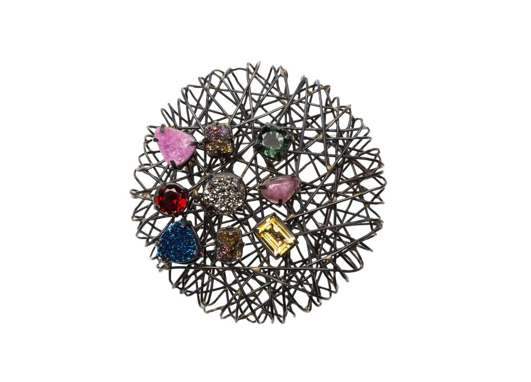 Natural gem stones adorn this pin made of wires by Jeong Ju Lee