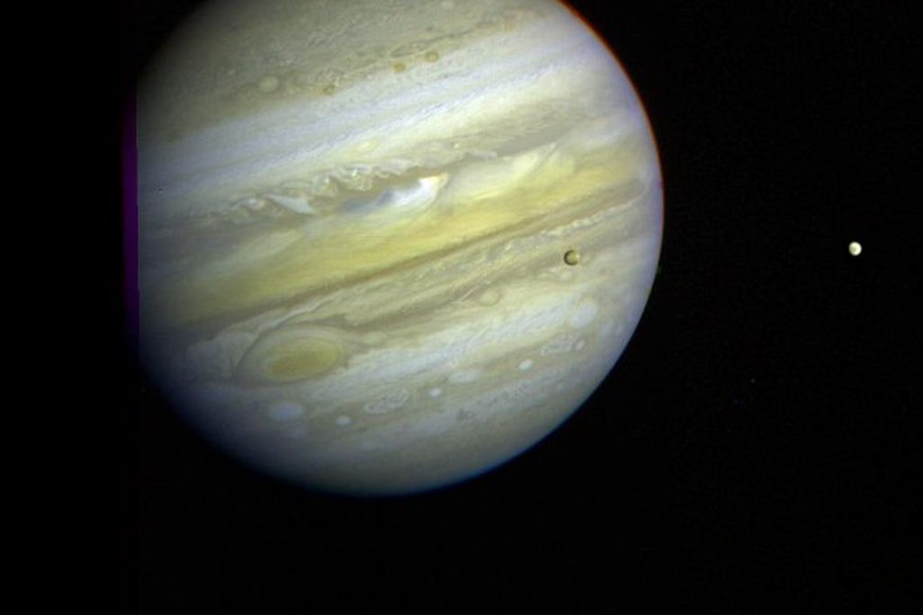 Three of Jupiter’s moons, Callisto, Io, and Europa can be seen orbiting the gas giant.