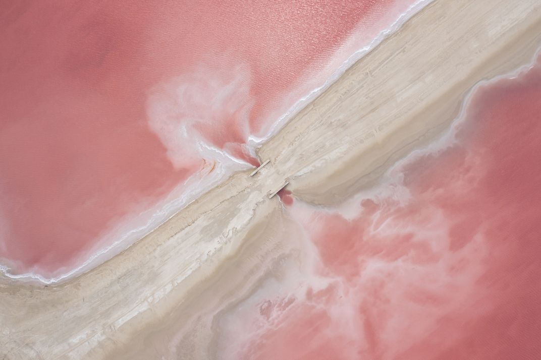 pink water surrounds sand