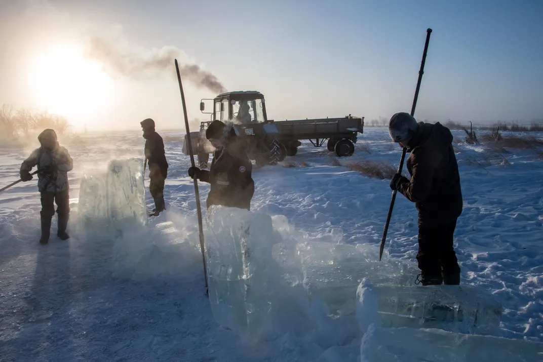 Villagers harvest ice