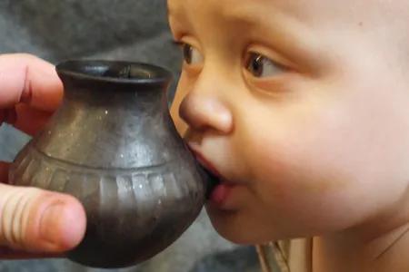 Modern-day baby feeding from reconstructed infant feeding vessel of the type investigated in the new study. 
