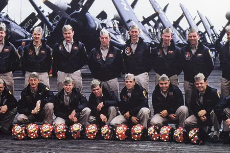 The squadron pilots pose on Valley Forge in July 1952, with 13 flight helmets for their fallen colleagues. Among the survivors are Cleland (back row, middle), Edinger (to his immediate left), and Balser (to Cleland’s right).