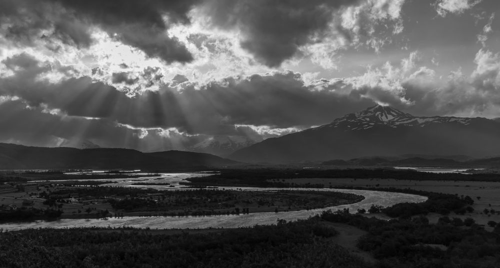 I captured this expansive river and mountain vista driving into Torres del Paine National Park, where the late day sunlight was not only reflecting nicely off of the river, but creating a fan of distinct streaks through the clouds.  The classic S-shape of the river was also appealing.