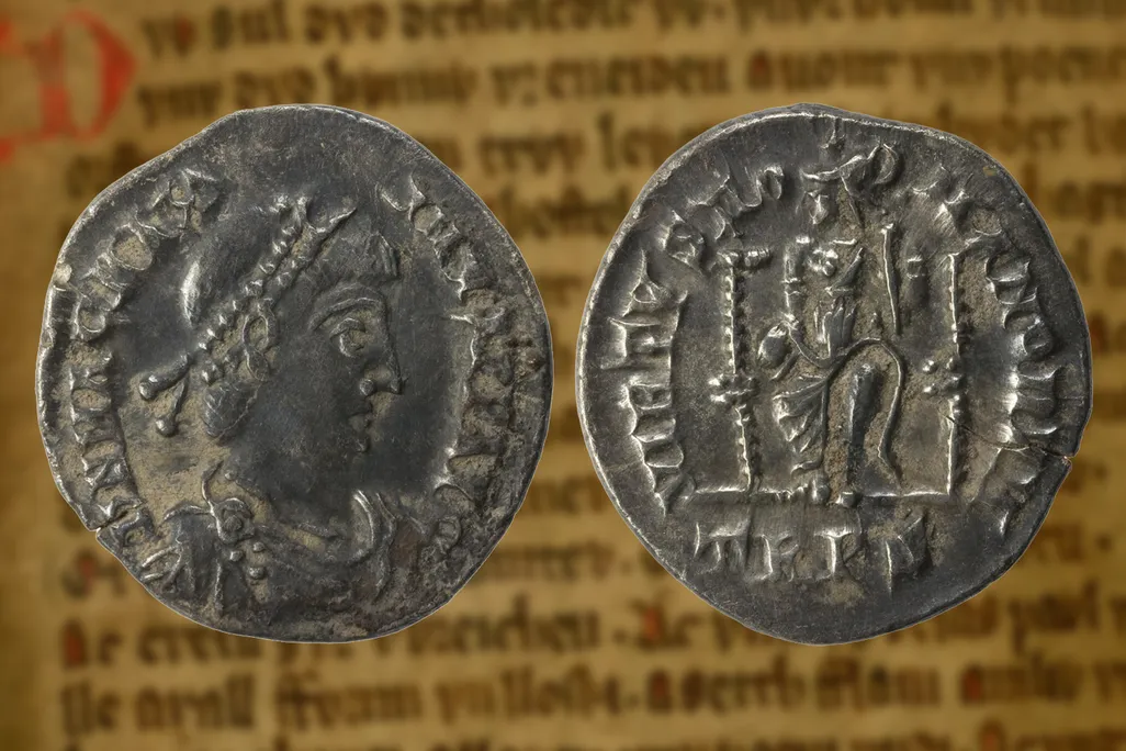 A coin bearing the likeness of the fourth-century C.E. Western Roman emperor Magnus Maximus, overlaid atop a page from a medieval manuscript of the Mabinogion​​​​​​​