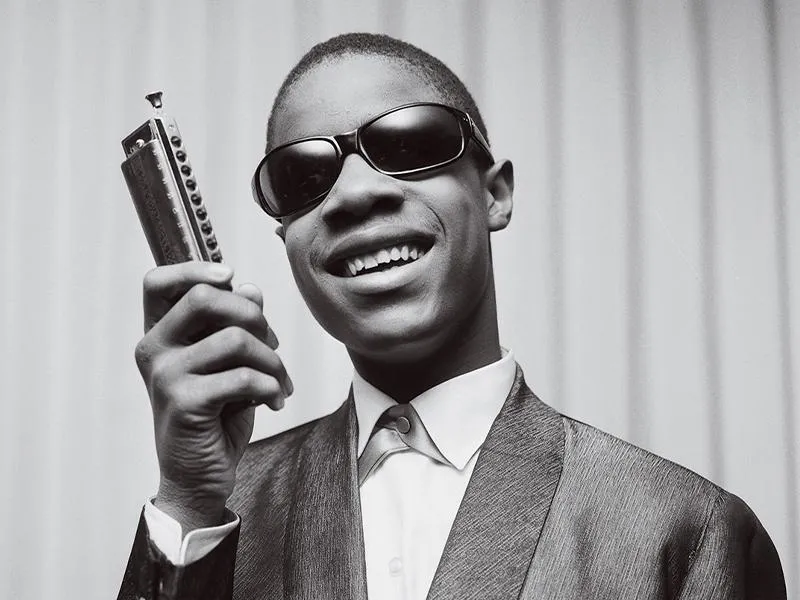 Stevie Wonder holding a harmonica