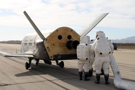 A little mystery: The Air Force X-37B mini-shuttle gets serviced after its landing at Vandenberg AFB in California last October.