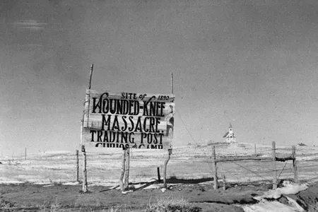 Dating from 1940, this photograph depicts a sign at the site of the Wounded Knee Massacre, South Dakota, where 250 American Indians were killed in 1890.