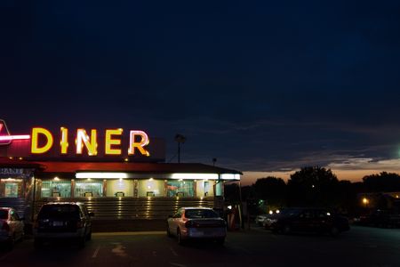 What is it about cheap eats, long hours, counters, and booths that so consistently captures the American imagination? 