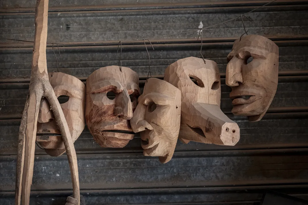 Unpainted Mamuthone masks hang at the workshop, along with a zoomorphic mask for another carnival in a nearby village. The most popular materials for these masks include alder, olive and cherry wood.