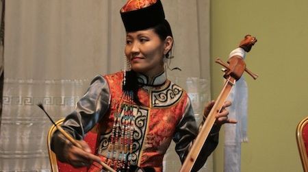 Ayana Mongush, a throat singer from Kyzyl in the Republic of Tuva, Russian Federation, plays an igil. She is part of Tyva Kyzy, an all-female throat singing group, a profession which was traditionally prohibited for women.