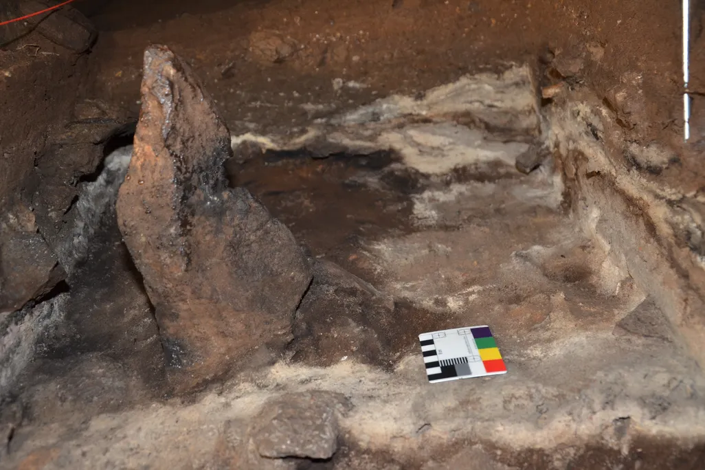 A stone standing upright inside a cave
