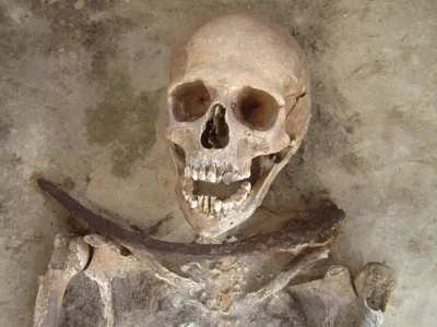 This relatives and friends of this 30-something-year-old woman suspected she might come back from the grave as a vampire, as indicated by the sickle placed directly across her neck, and meant to keep her in the ground.