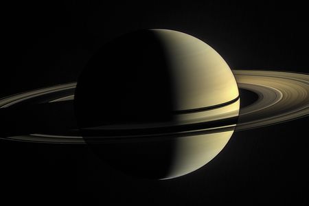 In the image captured by Cassini, the rings are illuminated both by direct sunlight and by light reflected off Saturn's cloud tops.