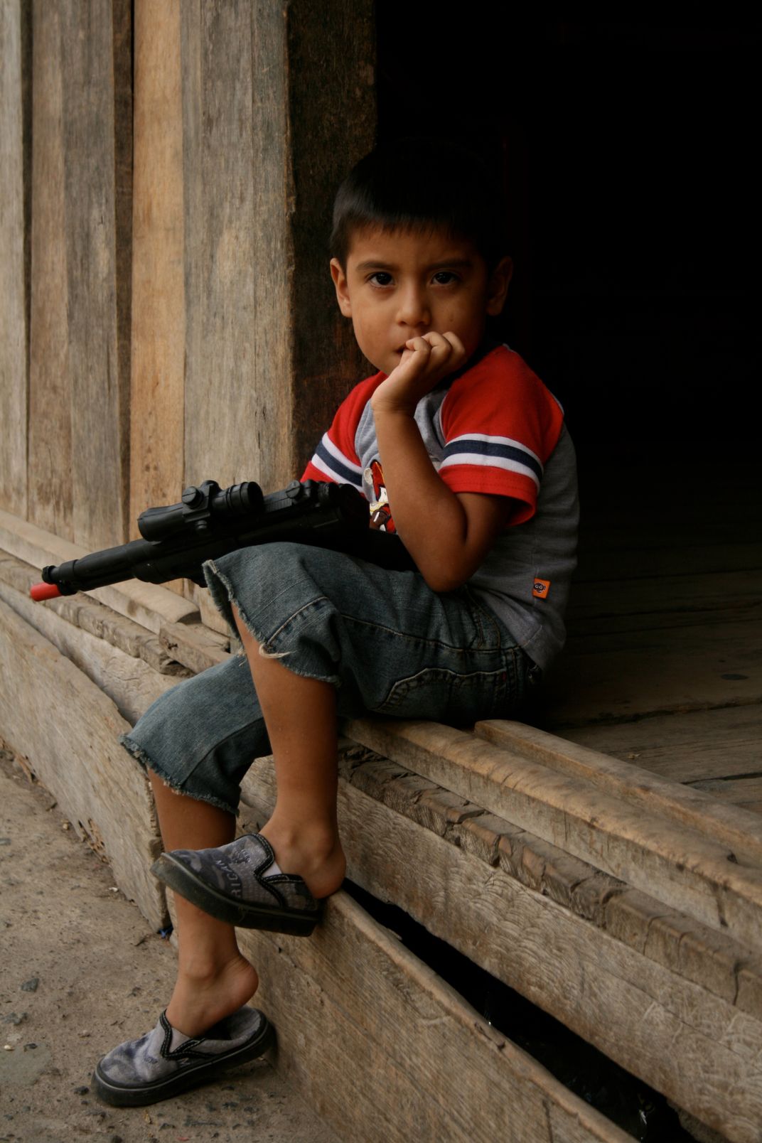 Child with toy gun in Mindo, Ecuador Smithsonian Photo Contest