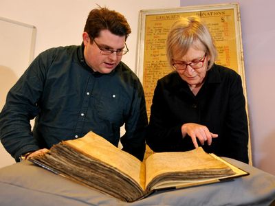 Gary Brannan, archivist, and Professor Sarah Rees Jones examine one of the archbishops' registers.

