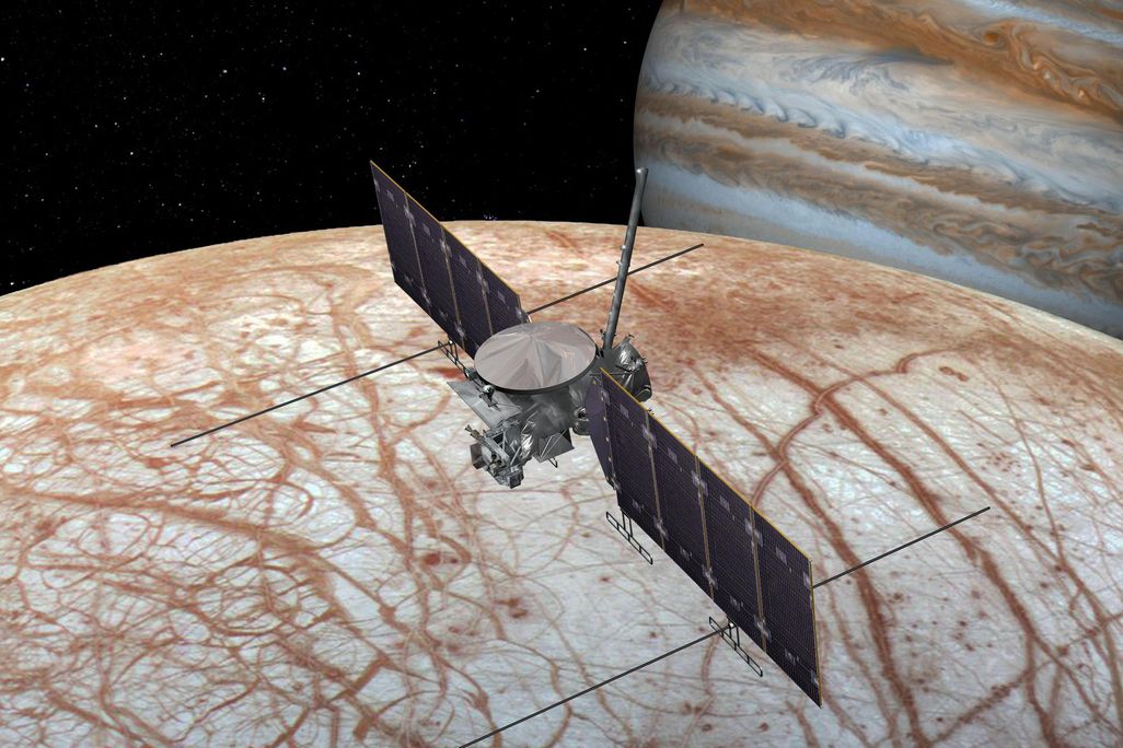 Artist's rendition of a spacecraft flying over Europa with Jupiter in the background