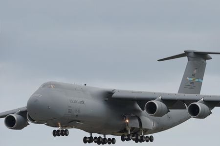During a 2015 training flight, a C-5M Super Galaxy on final approach prepares to slam 28 tires on the runway at Dover Air Force Base. The freighter is the largest operational aircraft flown by the Air Force.