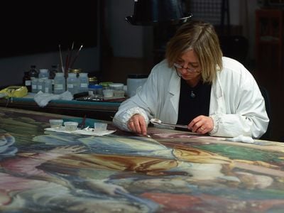 An expert at work on a painting at the Opificio Delle Pietre Dure